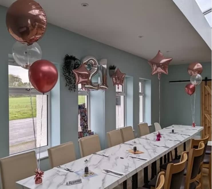 Cammies Restaurant 21st birthday party setup with retail balloons and minimal table decor.