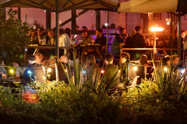 Outdoor reception space at Grow Hackney Wick with ambient string lighting for networking events.