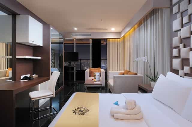 VIP guest room with workspace and lounge at Merlynn Park Hotel, ideal for business travel and events.