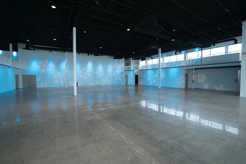 Industrial-chic Canvas Event Venue with polished concrete floors for holiday galas and corporate events.