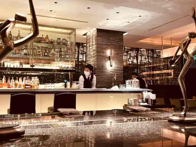 Sophisticated hotel bar with moody lighting for VIP receptions and corporate networking events.