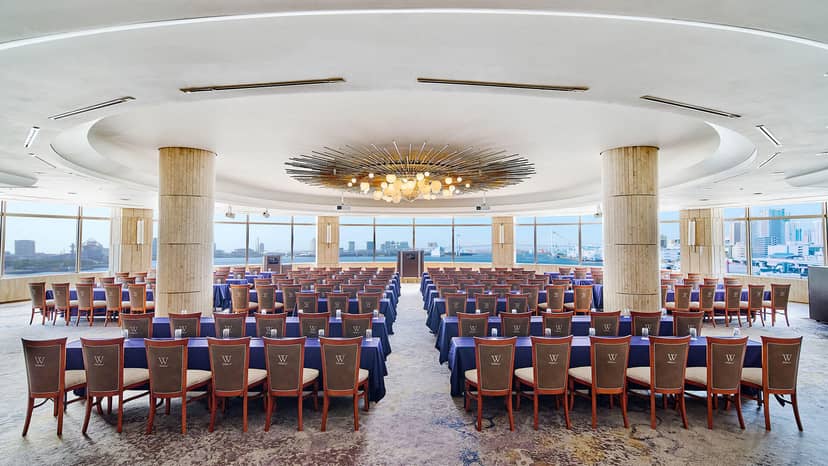 Circular plenary space with grand chandelier for executive training and corporate briefings.