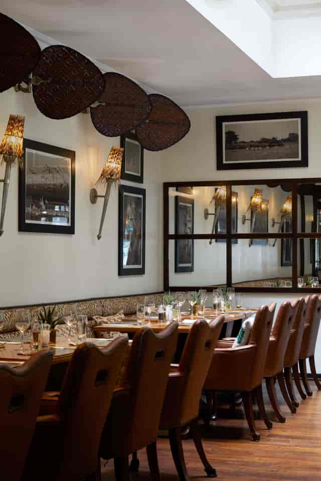 Stylish Upper Bar dining space with warm lighting for intimate gatherings and corporate dinners.