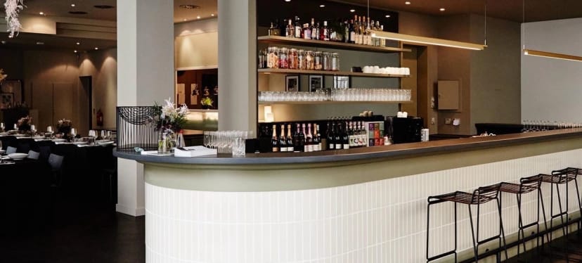 Modern hotel bar with sleek decor for corporate networking and professional conference events.