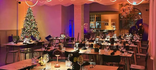 Festive corporate mixer at GOOSE Eventspace featuring ambient lighting and elegant table settings.