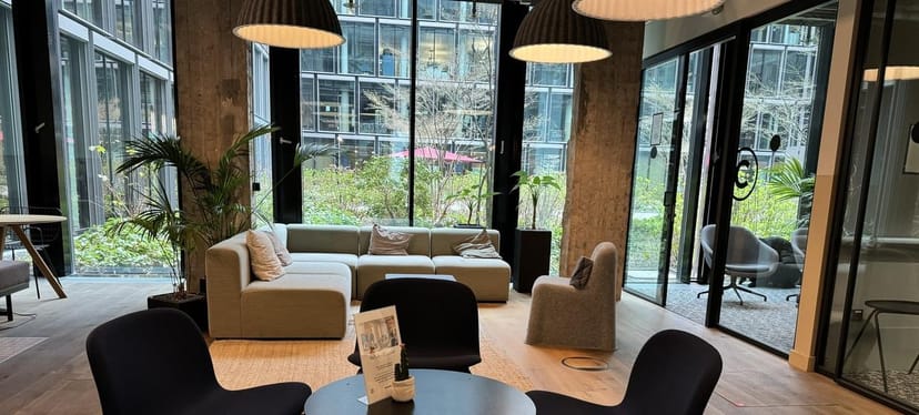 Junghof breakout space with modular seating and greenery for business networking and meetings.