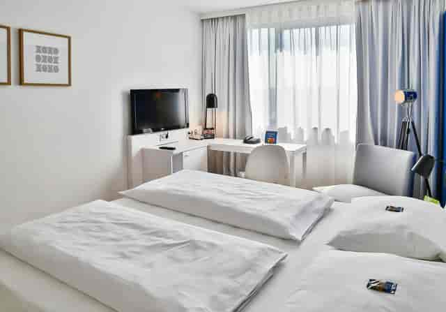Modern hotel room in Frankfurt for business travel with a quiet workspace.
