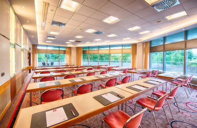 Classroom-style meeting room at Leonardo Royal Hotel Frankfurt, perfect for corporate conferences.