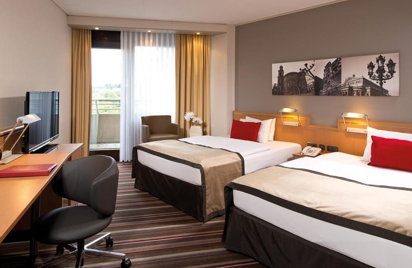 Leonardo Royal Hotel Frankfurt corporate guest room with workspace for business conferences.