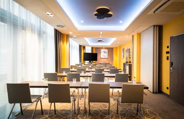 Classroom-style meeting room at Leonardo Royal Hotel Frankfurt for business conferences and seminars.
