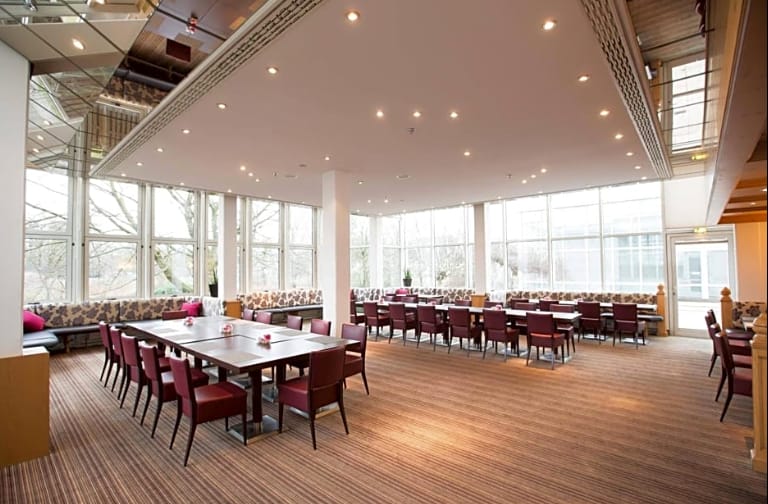 Meeting room with floor-to-ceiling windows at Crowne Plaza Frankfurt, ideal for corporate events.