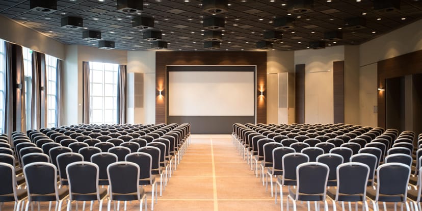 Theater-style conference room at Crowne Plaza Frankfurt with AV screen for keynote events.