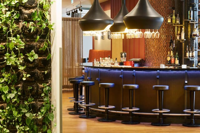 Sophisticated hotel bar for evening receptions and networking events with ambient lighting.
