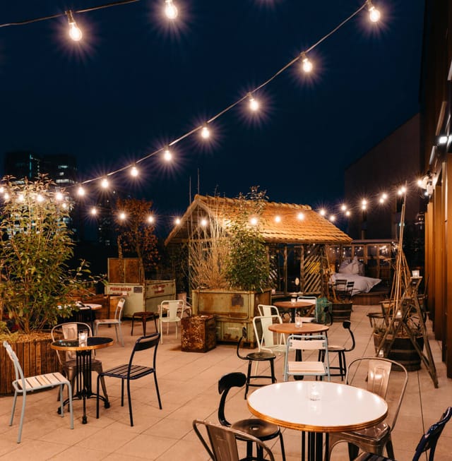Rooftop terrace with bistro lighting, ideal for evening networking and corporate breakout events.