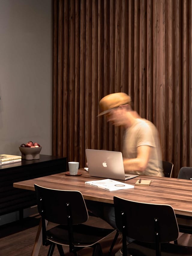 Acoustic wood-panel workspace at Bold Campus for focused conference breakout sessions.