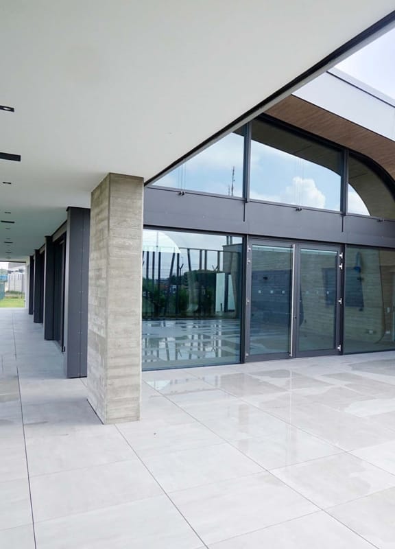 Modern minimalist event venue entrance with glass frontage for corporate registration.