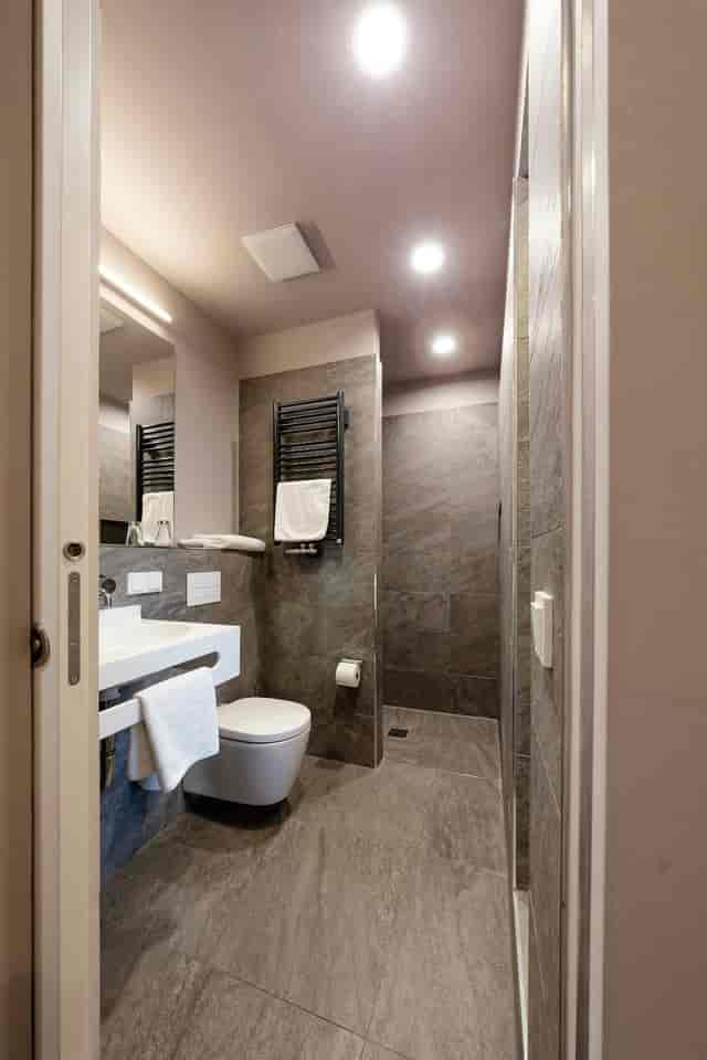 Modern luxury hotel bathroom with towel warmer for VIP event accommodation.