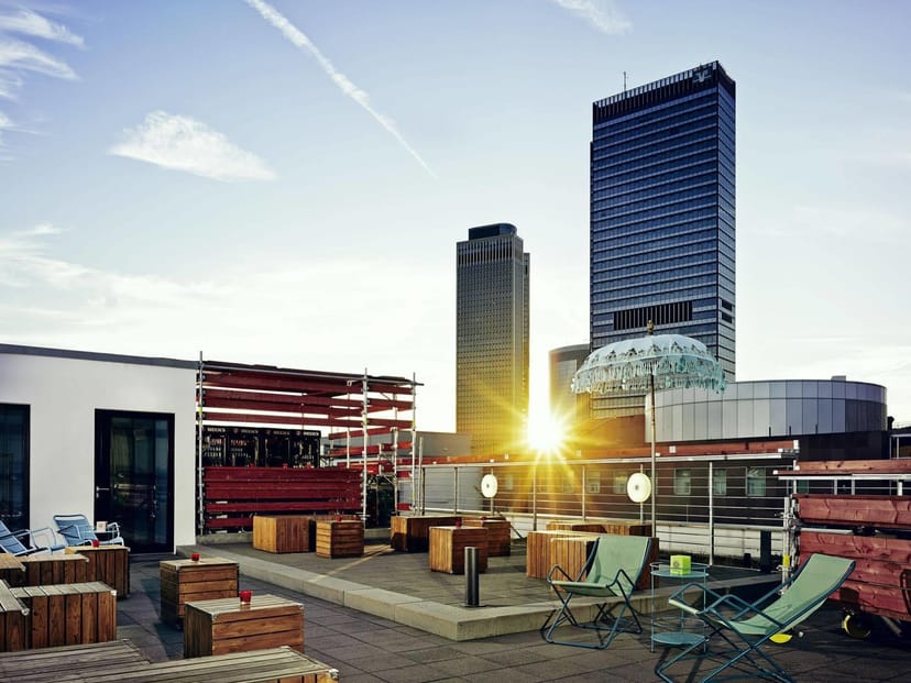 Rooftop terrace networking event at 25hours Hotel with trendy modular furniture for corporate events.