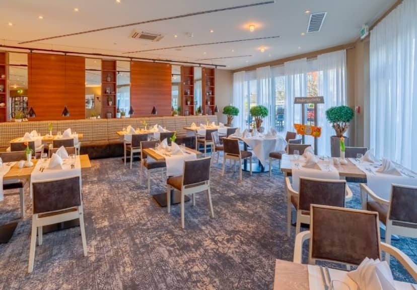 Modern banquet hall with natural light, perfect for corporate luncheons and business meetings.