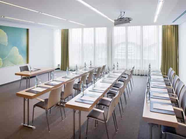 U-shaped boardroom in Mövenpick Restaurant with natural light for meetings and corporate workshops.