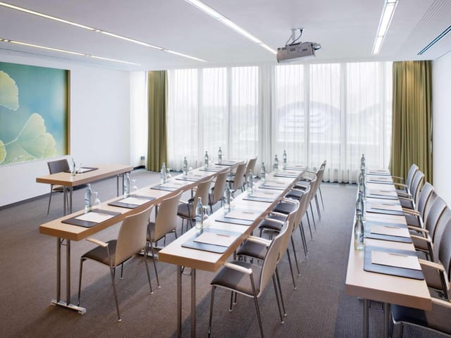 U-shaped boardroom in Mövenpick Restaurant with natural light for meetings and corporate workshops.