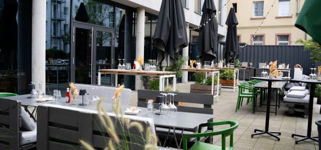 Courtyard Terrace: Contemporary outdoor space with modular seating for corporate mixers.