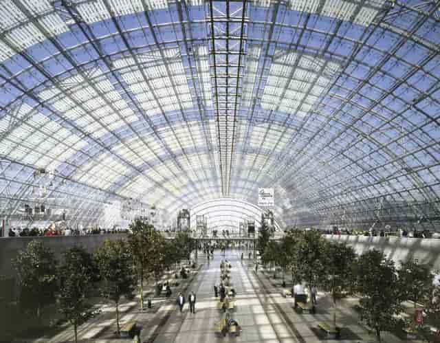 Glass hall at Leipziger Messe, sun-drenched atrium for networking events and exhibitions.