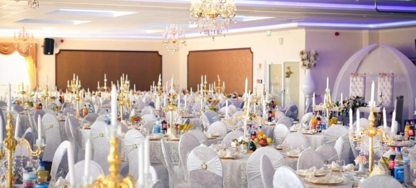 Congresium banquet hall with candelabra decor for wedding gala event.