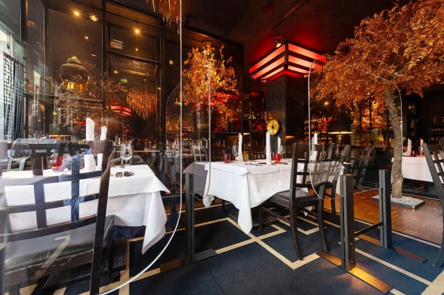 Luxury Zenzakan restaurant with plexiglass partitions for safe corporate event dining.