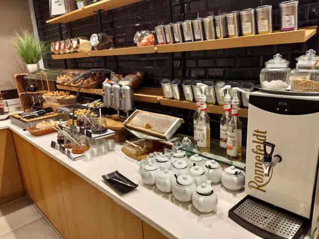 Hotel meeting room breakfast buffet with tea station for corporate events and catering.