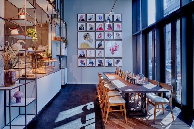 Coffee shop breakout space with communal table for creative workshops and board meetings.
