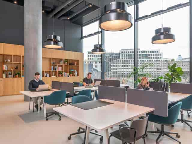 Modern private office at Spaces Omniturm with ergonomic desks for flexible coworking meetings.