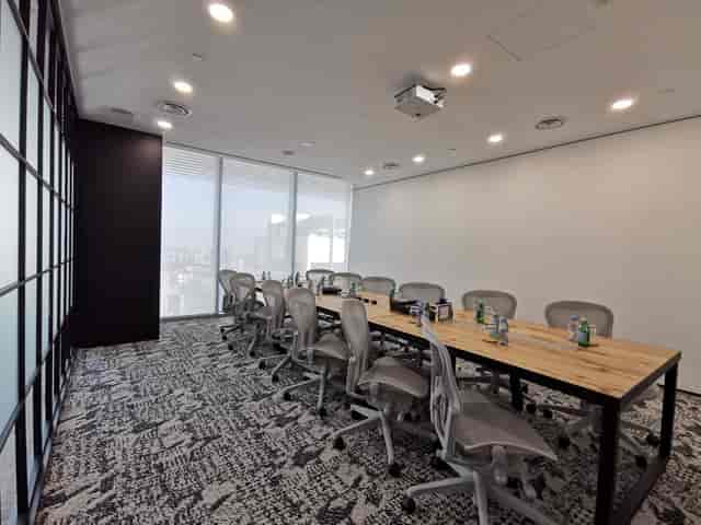 Modern boardroom with live-edge table and city views for executive meetings and corporate events.