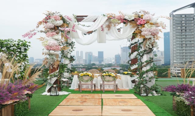 Rooftop Balai Sudirman event venue with floral arch for premium weddings and corporate galas.
