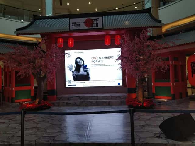 Grand Galaxy Convention Hall event activation with cherry blossom decor for brand engagement.