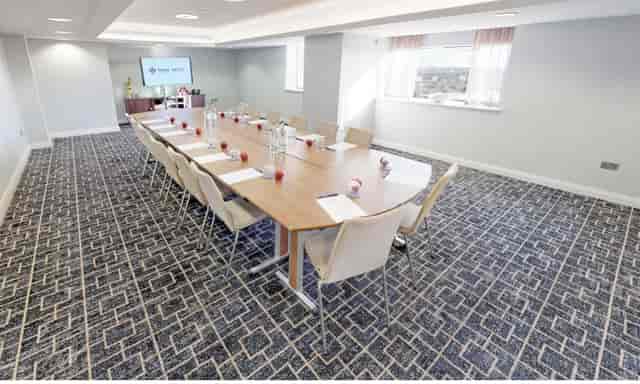 Meeting room at Park Regis Birmingham with polished table, ideal for professional gatherings.