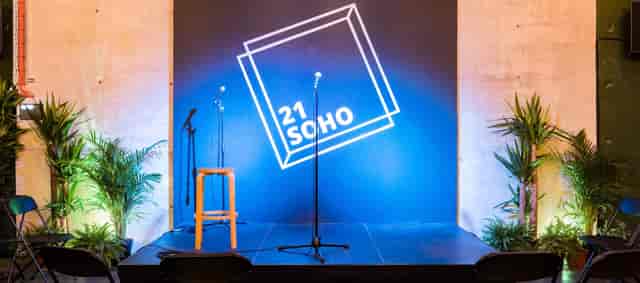 21Soho Main Space stage with mic and stool for stand-up comedy and speaker events.