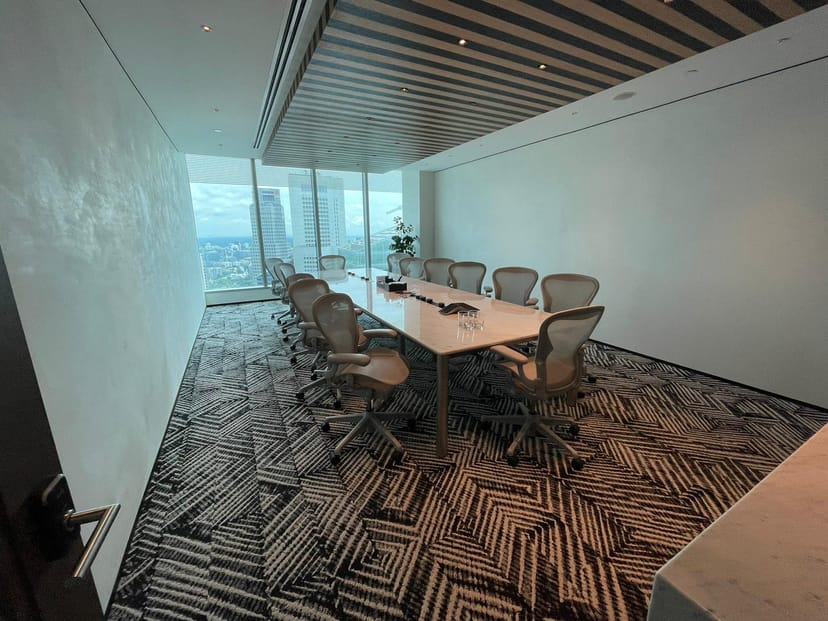 C-suite boardroom with skyline view for professional strategy sessions and corporate meetings.