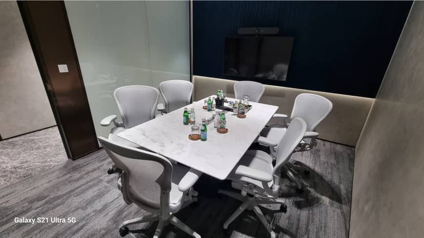 Modern 6-person boardroom with AV tech for professional hybrid meetings and corporate events.