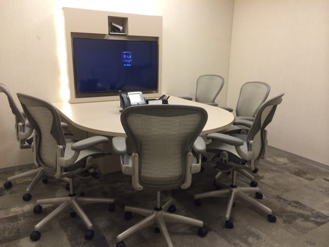 Tech-enabled 42B huddle room for small-group collaboration and corporate meetings.