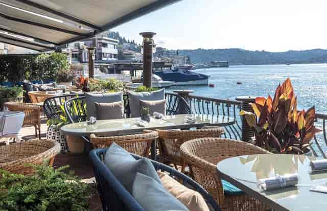 Waterfront bar at Bebek Hotel with outdoor seating, ideal for luxury receptions and events.