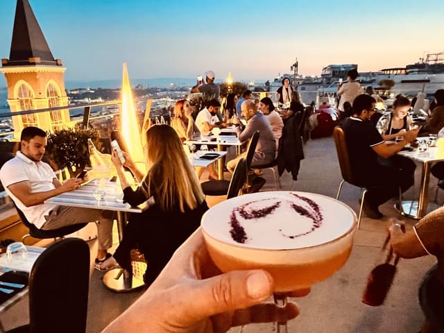 Rooftop networking reception at 360 Istanbul with golden hour skyline views.