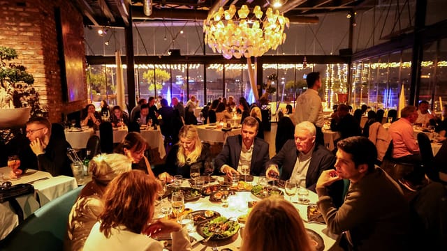 360 Istanbul restaurant evening reception with floor-to-ceiling glass for corporate events.
