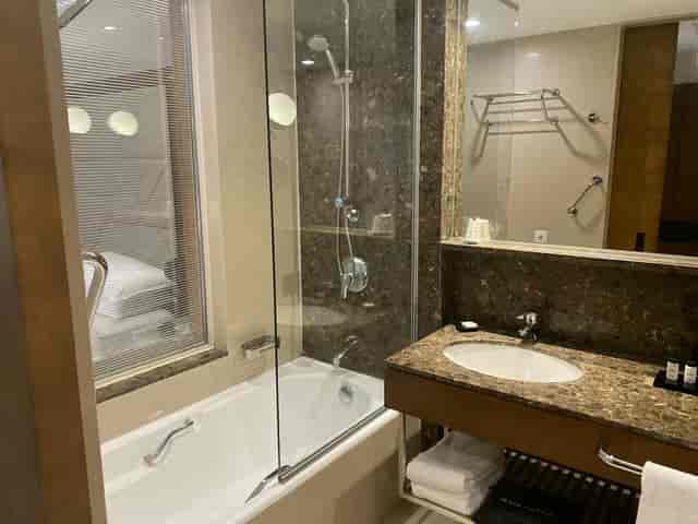 Sheraton Istanbul Levent premium bathroom, glass shower, hotel room block, group booking.