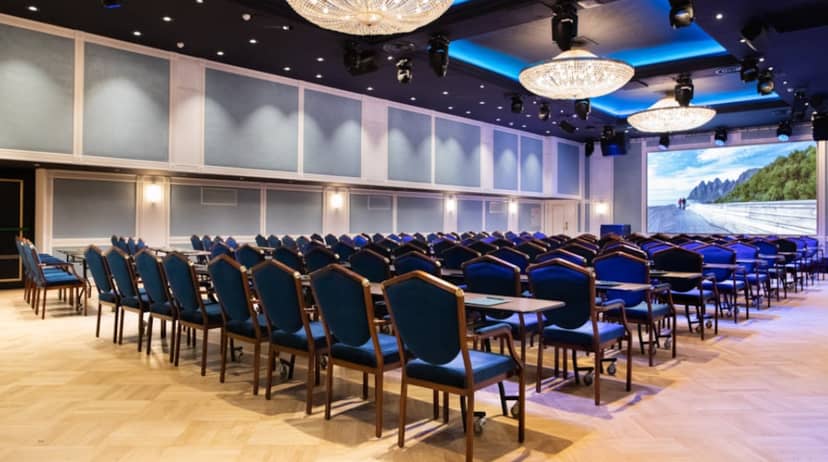 Maud Salen in elegant conference room with blue chairs for business meeting