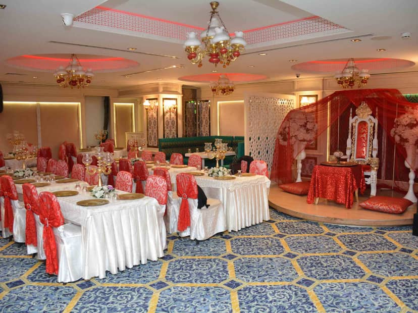Banquet wedding hall at Teras Labella with decorated dais and red-accented formal seating.