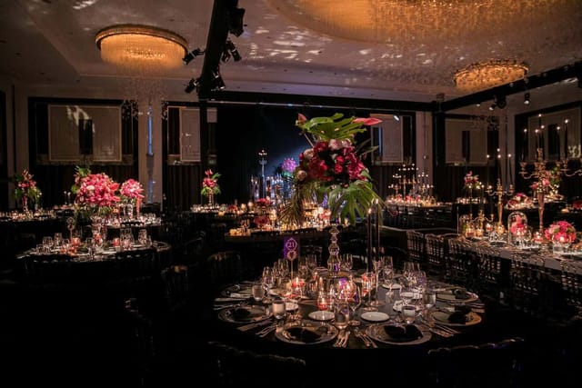 Luxury gala banquet hall at Hilton Istanbul Bomonti with dramatic lighting and floral decor.