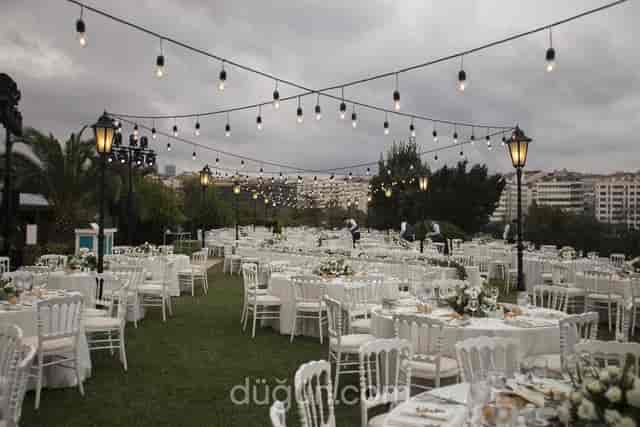 Outdoor wedding banquet setup with string lighting at Hilton Istanbul Bosphorus event hall.