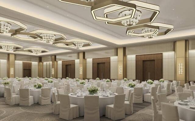 Luxury pillarless ballroom with geometric lighting, ideal for corporate galas and social events.