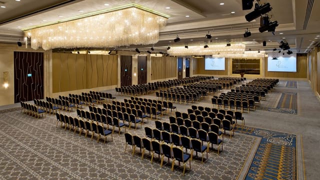Grand Tarabya Hotel ballroom with theater-style seating for corporate plenary event.